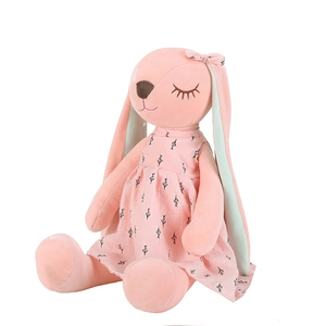 Plush bunny toy in pink dress with long ears and floral patterns in sitting pose
