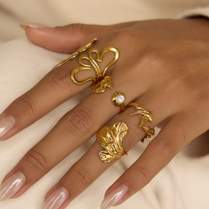 Detailed view of 18K gold plated ring set with leaf texture and zircon on model