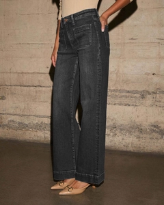 Detail of dark grey high-waisted wide-leg jeans with front patch pockets and denim texture