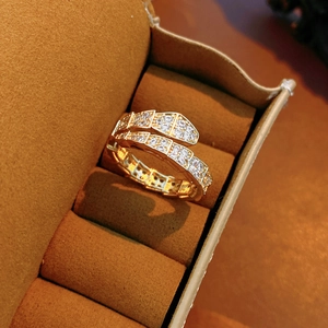 Macro detail of gold snake ring with micro-pave cubic zirconia in a velvet box