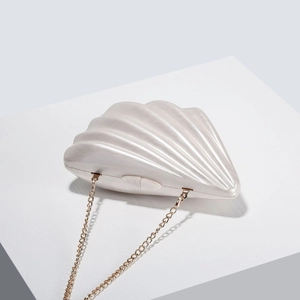 Elegant ivory shell shaped acrylic clutch bag with a gold chain strap for women's evening gala
