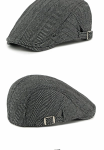 Macro detail of classic black and grey herringbone fabric and metal buckle on ivy cap