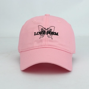 Close-up of pink baseball cap featuring black butterfly embroidery and Love Poem text