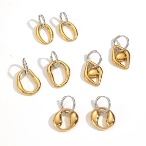 Set of four stainless steel hoop earrings with irregular gold pendants on white background