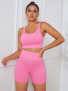 Detailed close-up of pink high-waist yoga set featuring a jacquard knit texture design