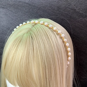 Handmade gold wire crown headband featuring white sea pearls on a golden mannequin