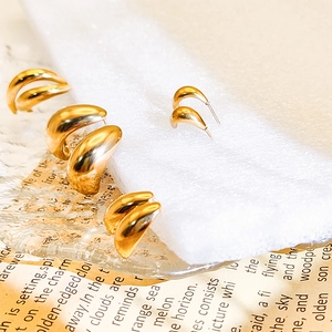 Macro shot of 18K gold-plated teardrop earrings with a glossy metallic finish