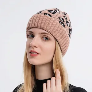 Women's leopard print knitted beanie in beige with rib-knit cuff on a model