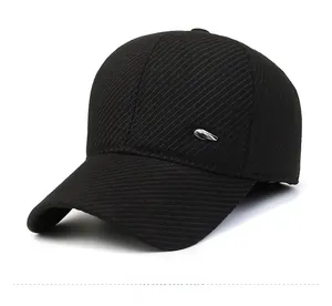 Detail of black winter baseball cap showing thick twill fabric and fashion metal plaque