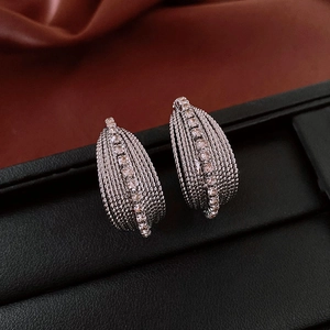 Detail of silver twisted layered hoop earrings with sparkling crystal pavé setting