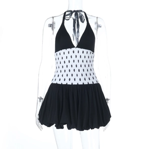 Detail of polka dot halter dress featuring elastic pleated waist and puff bubble hemline