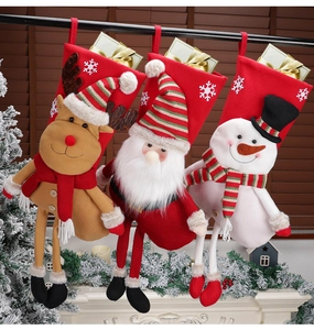 Detailed view of large plush Christmas stockings with 3D reindeer, Santa and snowman designs