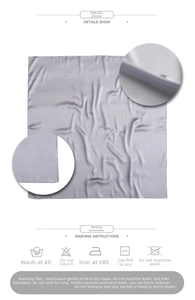 Detail of silver-grey silk square scarf featuring high-quality rolled edges and satin texture