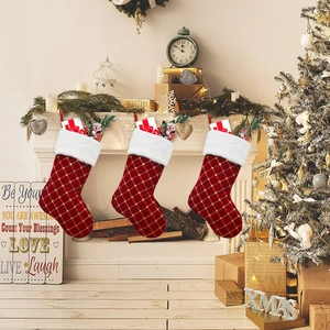 Close-up of red velvet Christmas stockings with gold grid sequins and faux fur trim