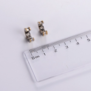 Minimalist stainless steel grooved hoop earrings in silver and gold with size ruler