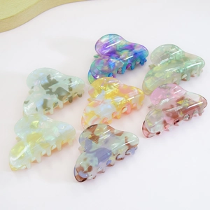 Set of 8 vintage heart-shaped hair clips in various marble textures and colors