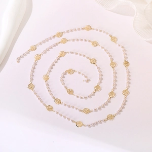 Close-up of elegant gold rose charms and white faux pearls on a versatile long necklace