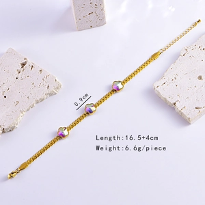 Gold Cuban chain bracelet with colorful crystal flower charms on white display stones