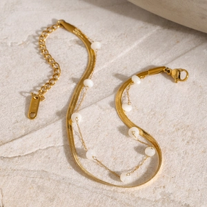 Detail of 18K gold stainless steel snake chain anklet with round white shell beads
