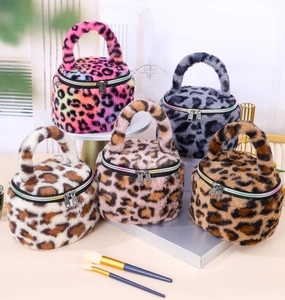 Stylish leopard print plush cosmetic bags in various colors featuring top handle design