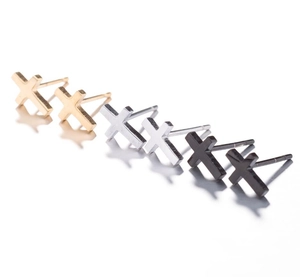 Detailed close-up of mini cross stud earrings in gold, silver, and black finishes