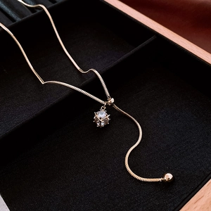 Macro view of gold plated snake chain with a sparkling cubic zirconia pendant
