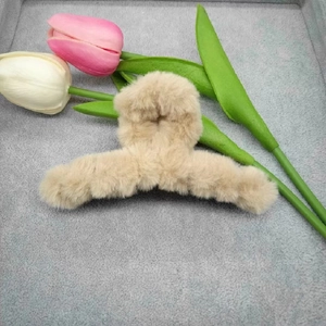 Detail of 11cm beige plush hair claw clip with soft faux fur and tulip flower decor