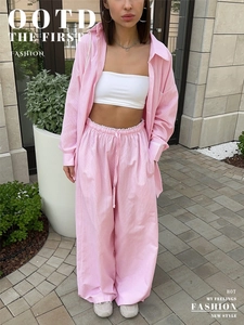 Detailed view of women's pink striped long-sleeved shirt and matching wide-leg pants set