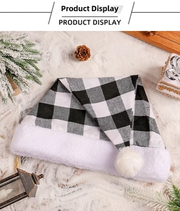 Detail of black and white buffalo plaid Christmas hat on festive winter snow background