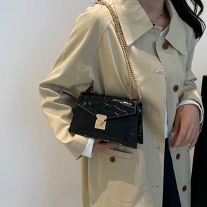 French vintage black crocodile pattern shoulder bag with gold chain strap on model