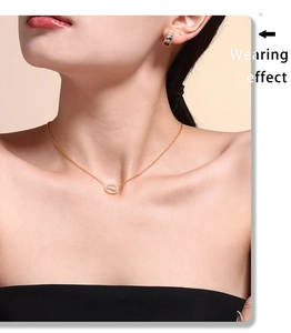 Detail of 18k gold plated necklace featuring an oval pendant with micro-pave crystals