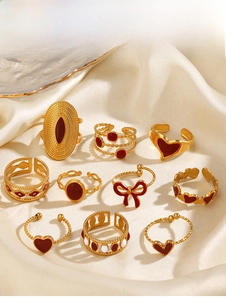 Detailed set of ten vintage gold rings with red enamel hearts and pearl butterfly accents