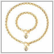 Detail view of gold heart pendants with rhinestones and toggle clasp on chain set
