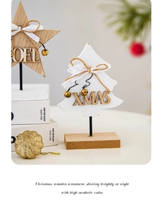 Detail of wooden Xmas and Noel desk ornaments with gold bells and silk bows on wood base