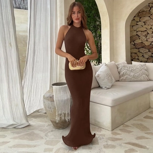 Detailed texture of the dark brown halter neck maxi dress in a scenic resort setting