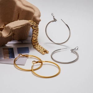 Polished gold and silver hoop earrings with matching metal link watch band set