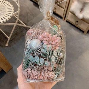 DIY Christmas decoration kit with pink pinecones, berries and silver ornaments in a clear bag