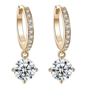 Detail of gold hoop earrings with sparkling round zircon in a four-prong setting