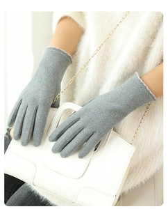 Detail of grey thermal gloves with pink accents and touchscreen feature on winter gloves