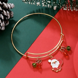 Detail of adjustable gold Christmas bangle with Santa charm and red green crystal beads