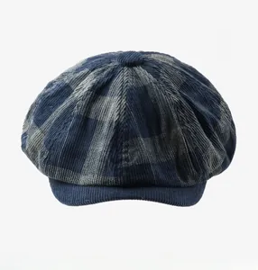 Gros plan détaillé sur le velours côtelé bleu à carreaux et le bouton de la casquette