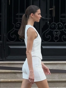 Women's minimalist white sleeveless vest and high-waist shorts set for summer style