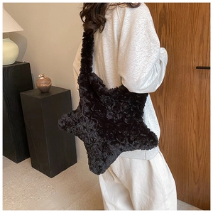 Close-up of star-shaped plush crossbody bag showing fluffy texture and wide strap