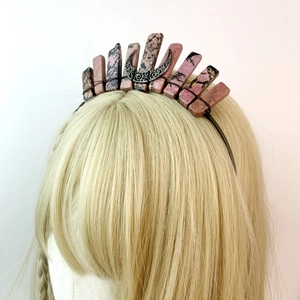 Detail of pink crystal crown featuring a silver triple moon symbol on black headband