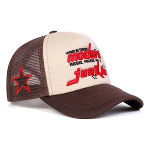 Detail of red 3D embroidery and breathable mesh on a vintage street trucker hat