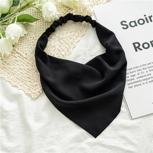 Close-up of black solid color chiffon triangle kerchief headband on lace background