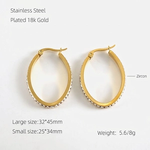 Detailed view of oval 18k gold plated stainless steel hoop earrings with zircon stones