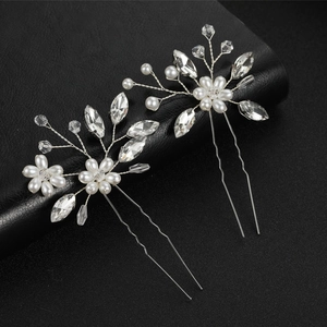 Elegant bridal hair pins set with white pearls and crystals on silver metal wire