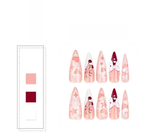 Detail of pink gradient press-on nails with 3D bows, pearls, and heart star motifs