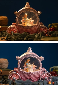 Close-up of pink carriage music box with warm LED lighting and fairy tale figures